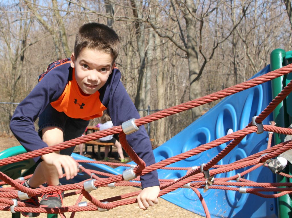 Boys Climbing in Inclusive Playground