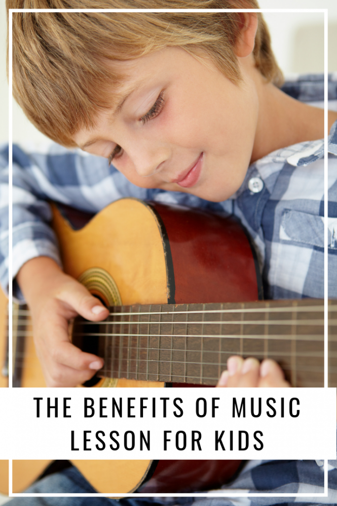 Boy playing guitar after music lessons